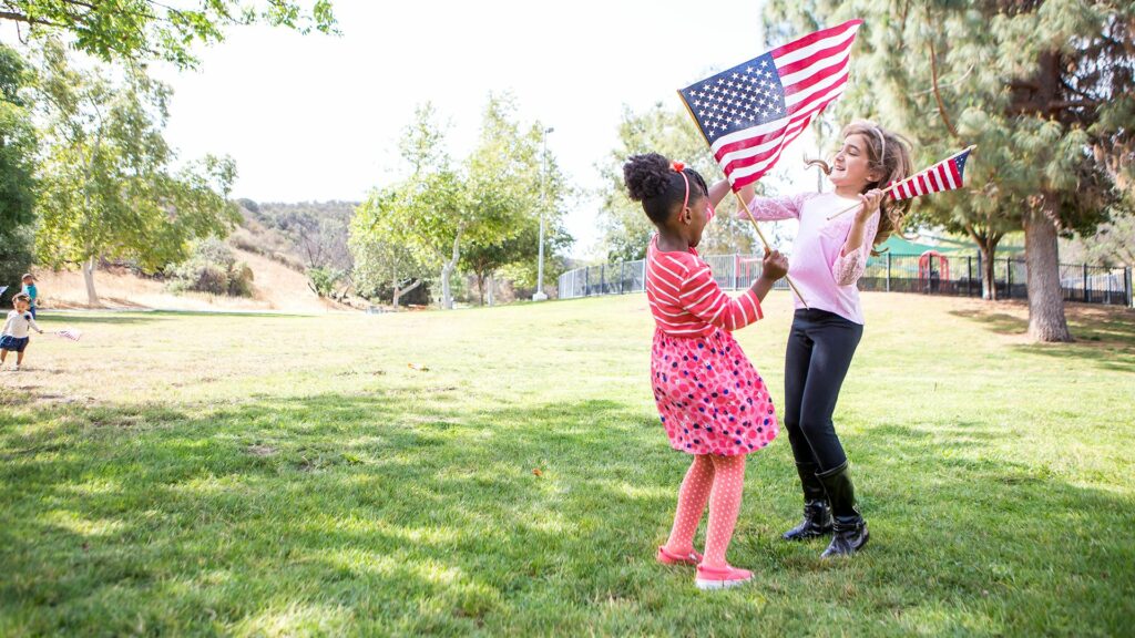 Green Card Renewal - Girls playing with flag