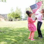 Green Card Renewal - Girls playing with flag